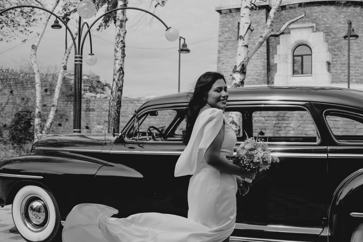 Black-and-white photo of model with 1940s silk tulle veil over slicked-back bun, wearing modern turtleneck—editorial style