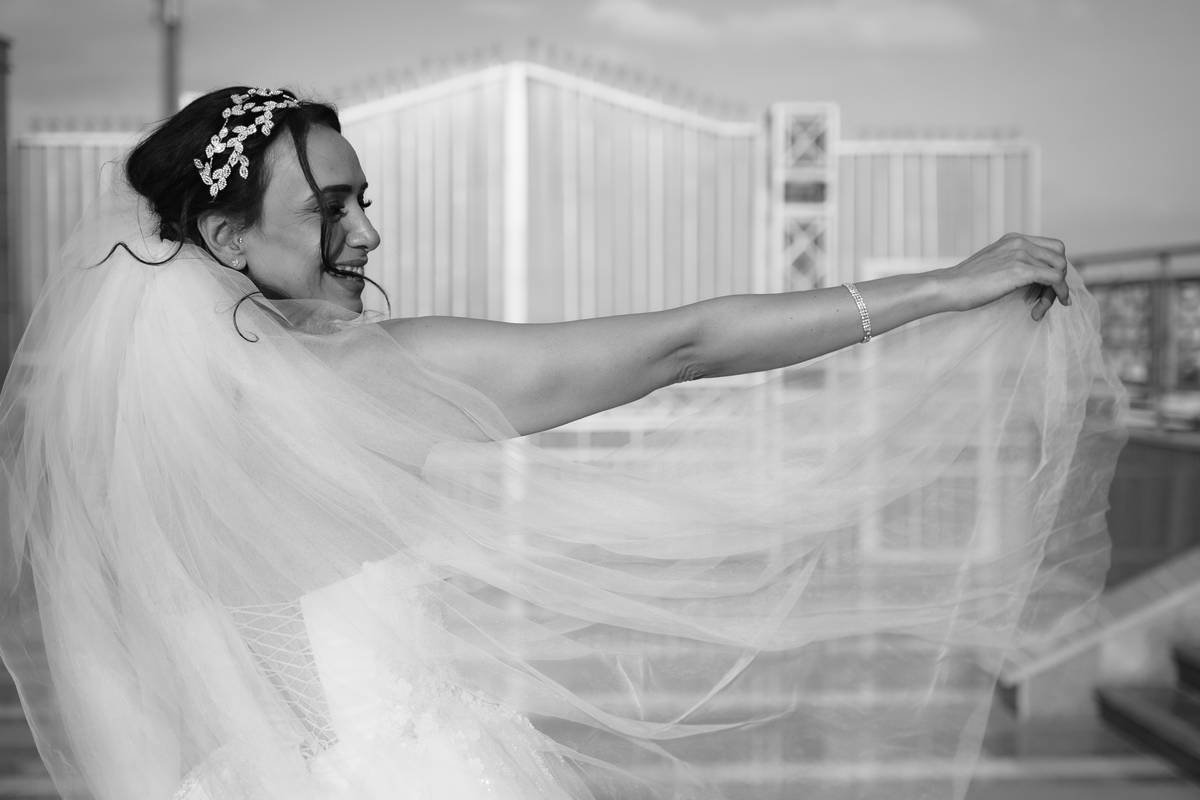 Close-up of hand-embroidered floral motif on ivory tulle veil showing fine silk thread detail and subtle bead accents