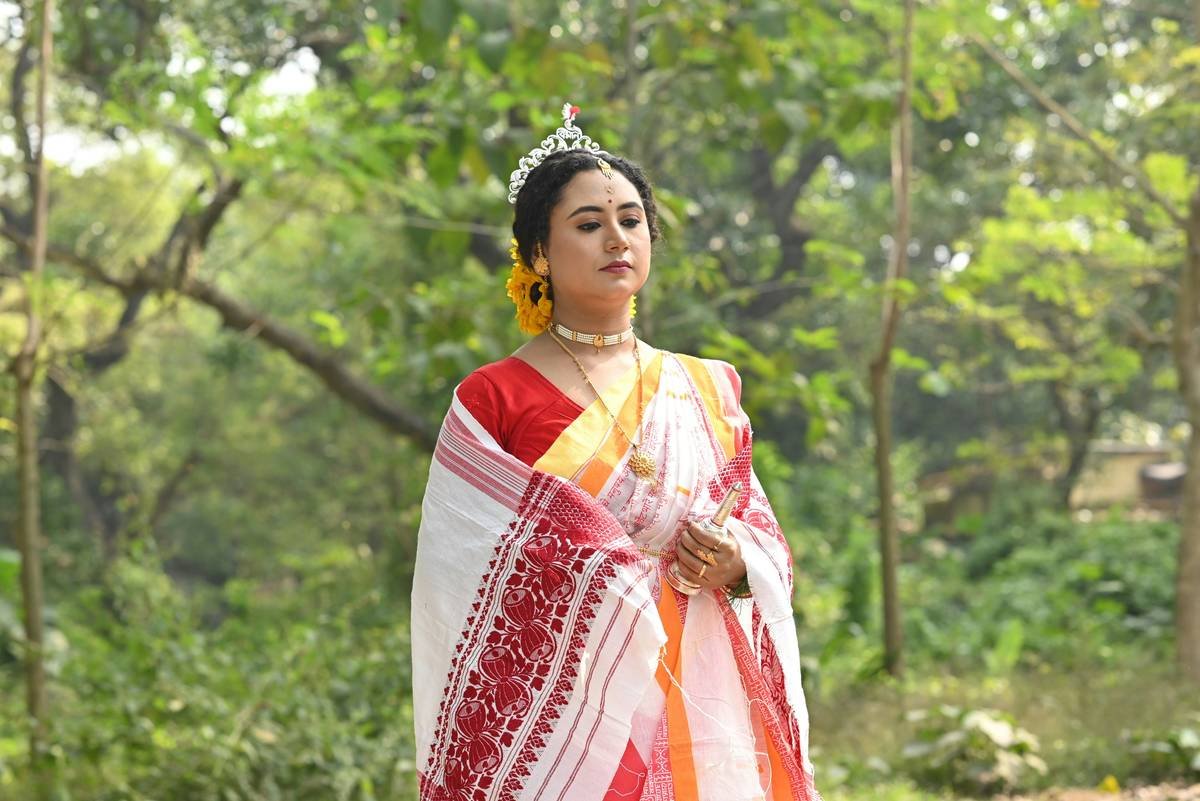 Woman wearing authentic ethnic headpiece with silk veil at cultural ceremony