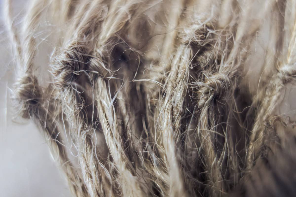Side-by-side comparison: left shows stiff, shiny synthetic veil; right shows soft, matte silk-blend artisan hair veil with delicate scalloped edge