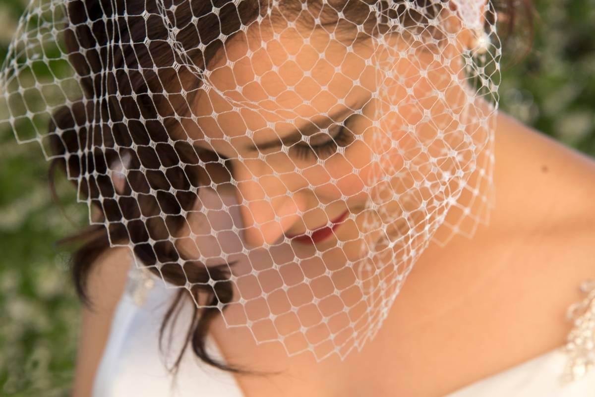Bride wearing a dramatic statement hair veil with cathedral-length tulle and embellished edge